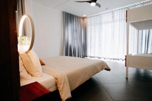 a bedroom with a bed and a large window at Palalong Views in Dumanjug +19 photos