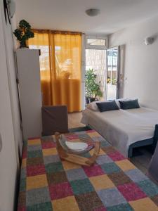 a bedroom with a bed and a table and a couch at Guest House Oscar near the Sea and river in Mokošica