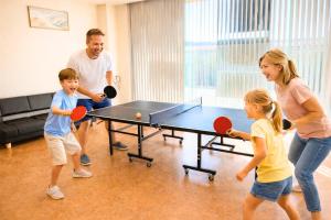 a group of people playing a game of ping pong at Magokoro House 202 in Nishiizu