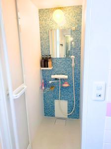 a bathroom with a shower with a sink and a mirror at Magokoro House 202 in Nishiizu +55 photos