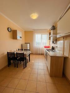 a kitchen with a table and a dining room at Apartments Domovik on Beregovskaya 3 in Mukacheve