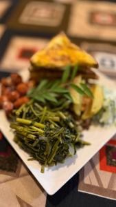 a plate of food with vegetables and a sandwich at MOYE MOYE Ella in Ella