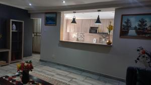 a living room with a counter and a kitchen at The Palace in Pretoria