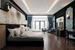 a bedroom with a large bed and a desk at Đại Cồ Việt Hotel Ninh Bình in Kỳ Vĩ