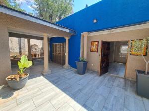 a blue building with a patio with plants on it at The Palace in Pretoria