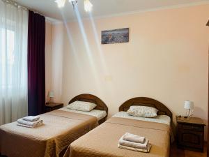 a room with two beds with towels on them at Apartments Domovik on Beregovskaya 3 in Mukacheve