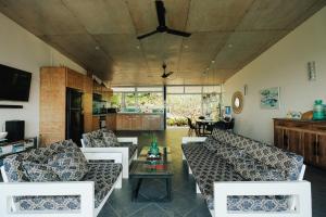 a living room with couches and a table at Balay Kalachuchi in Barili