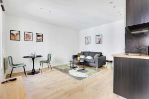a living room with a couch and a table at Charming studio for 2P - near Parc Monceau in Paris