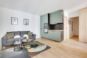 a living room with a couch and a kitchen at Charming studio for 2P - near Parc Monceau in Paris +4 photos