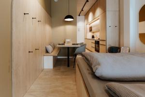 a bedroom with a bed and a desk and a table at Quartier 90 in Wietmarschen