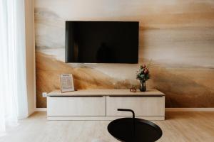a living room with a tv on a wall at Quartier 90 in Wietmarschen