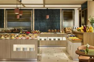 a restaurant with a buffet line with food at NH Collection Marbella in Marbella