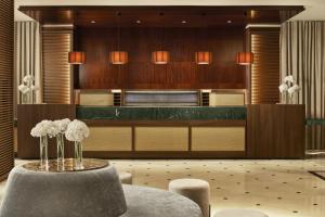 a lobby with a table with flowers on it at NH Collection Marbella in Marbella +31 photos