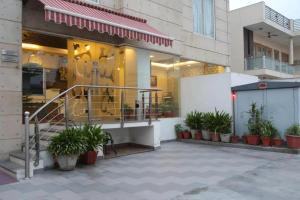 a store front with potted plants in front of it at Hotel Tushar Elegant in Ghaziabad
