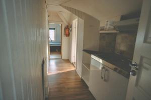 a kitchen with a sink and a counter top at Chase Base Budget-Friendly Rooms in Tromsø