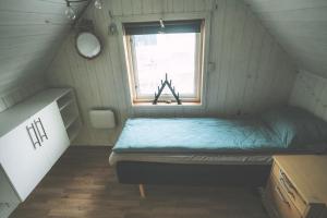 a small room with a bed and a window at Chase Base Budget-Friendly Rooms in Tromsø