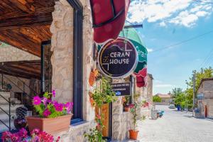 a sign for a german house on the side of a building at Ceran Stone House in Göreme