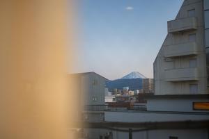 a view of a building with a mountain in the background at wanderlust STAY in Kofu +36 photos