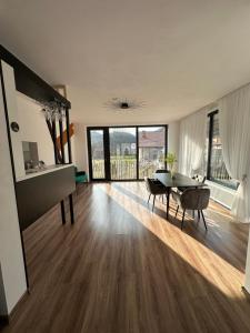 a large living room with a table and chairs at Casa Montwis in Brezoi