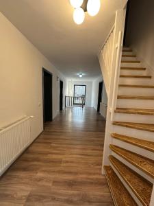 an empty hallway with stairs in a house at Casa Montwis in Brezoi