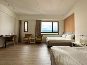 a hotel room with two beds and a desk and chairs at 9 Tan Yuan Homestay in Jiaoxi +75 photos