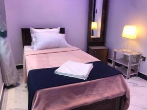 a bedroom with two beds and a mirror at Sevmeth Villa in Kandy