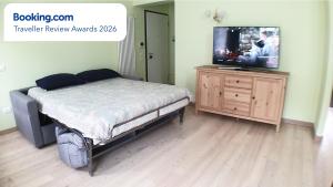 a bedroom with a bed and a tv on a dresser at Asiago Millepini in Asiago