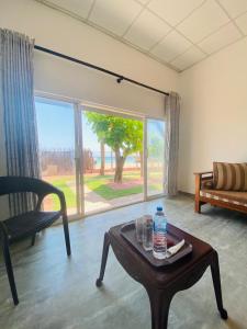 a living room with a table with a water bottle on it at Chanco Beach Hotel and Coworking - Negombo in Negombo