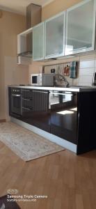 a kitchen with a sink and a counter top at I sogni di viola in Saluzzo