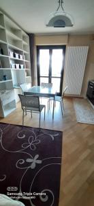a living room with a table and chairs and a rug at I sogni di viola in Saluzzo +11 photos