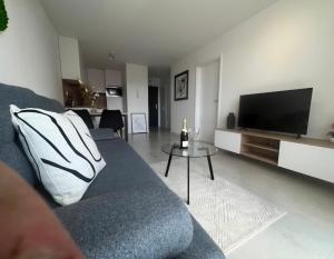 a living room with a couch and a flat screen tv at Nová rezidencia, 7 minut pešo do centra in Košice