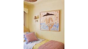 a bedroom with a bed and a picture of a dolphin at Designed By Three Birds Renovation in Pearl Beach +11 photos