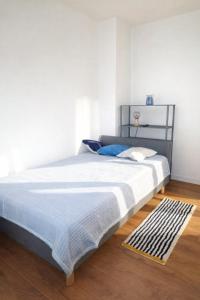 a bedroom with a large bed with white walls at Holiday Home Roza in Mirce