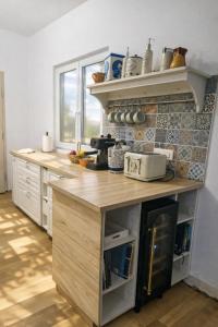 a kitchen with a wooden counter top in a room at Holiday Home Roza in Mirce +25 photos