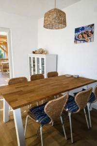 a dining room with a wooden table and chairs at Holiday Home Roza in Mirce
