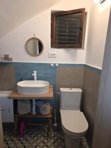 a bathroom with a toilet and a sink at Holiday Home Roza in Mirce