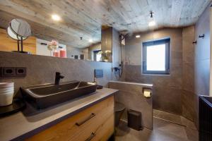 a bathroom with a sink and a mirror at Alpenchalet am Lech in Ehenbichl +22 photos