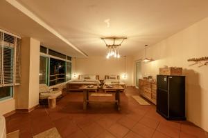 a living room with a table and a refrigerator at Êlim House in Phú Quốc +32 photos