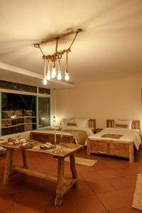 a living room with two beds and a table at Êlim House in Phú Quốc