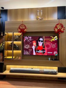 a television screen with a woman on it in a store at Trang Due homestay in An Dương