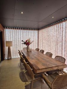 a conference room with a wooden table and chairs at Inspire Residence and private Wellness in Tongeren +91 photos