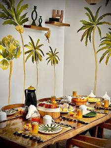 a table with food on it with palm trees at Riad Reflet D'orient Marrakech in Marrakesh