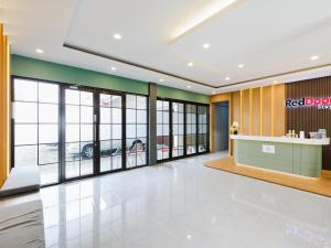 a lobby of a red door store with large windows at RedDoorz Plus Ciapus Bogor in Cimanglid