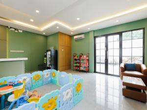 a childrens play room with green walls at RedDoorz Plus Ciapus Bogor in Cimanglid