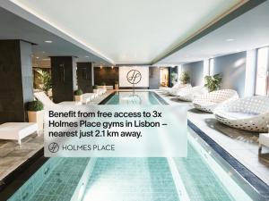 a pool in a hotel with a sign that reads benefit from free access to x at LSA Santos by Numa in Lisbon