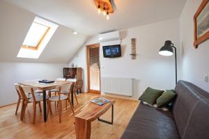 a living room with a couch and a table at Guesthouse S in Luče