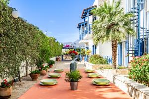 a long table with plates and plants on a street at Sand Garden Apart, Easy Stay by Heraklion Coast in Ayía Marína