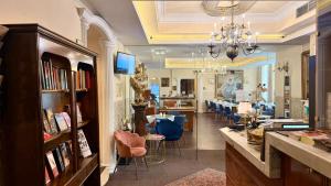 a room with a store with tables and chairs at Hotel Pension Excellence in Vienna