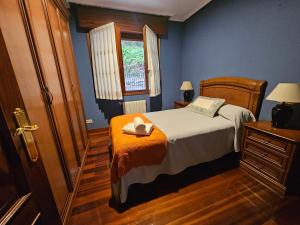 a bedroom with a bed and a window at Casa Villadam in Ribadesella