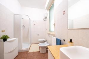a white bathroom with a shower and a toilet at Verdi Bilo Roseto Vacanza in Roseto degli Abruzzi